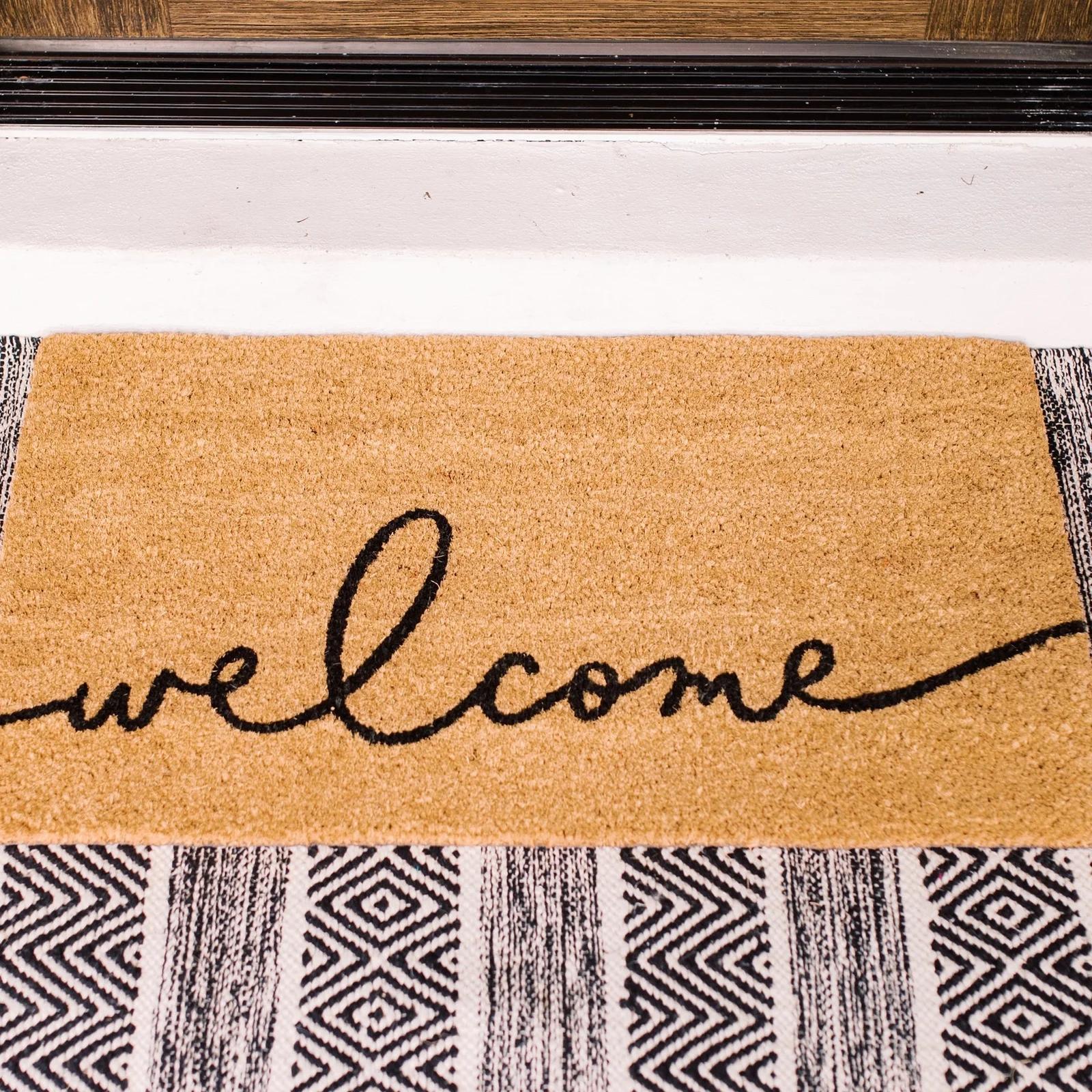 A+ content tile — welcome mat with plants
