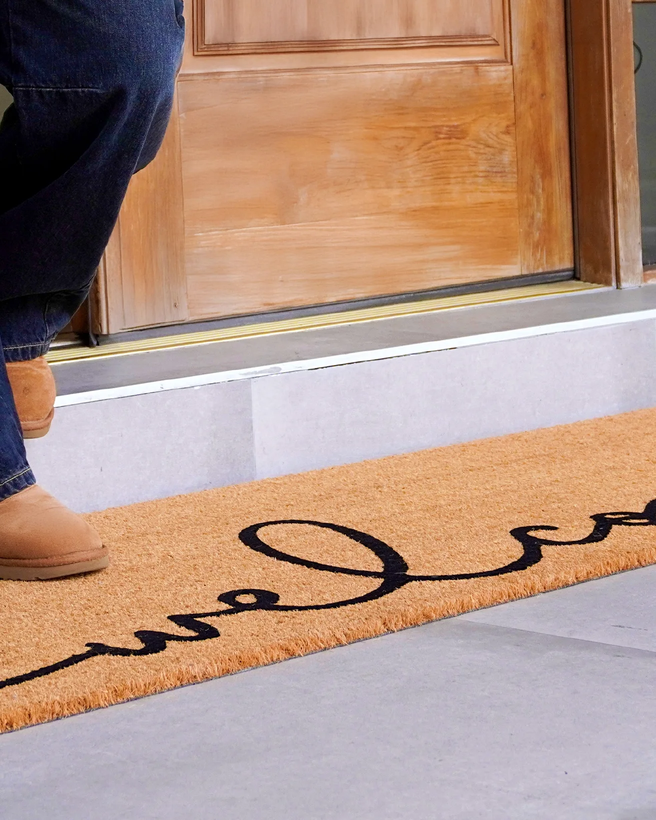 Doorstep still — the welcome mat at the door
